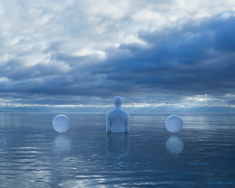Person and two white balls in the water